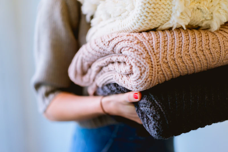 Mother and daughter folding laundry together at home
